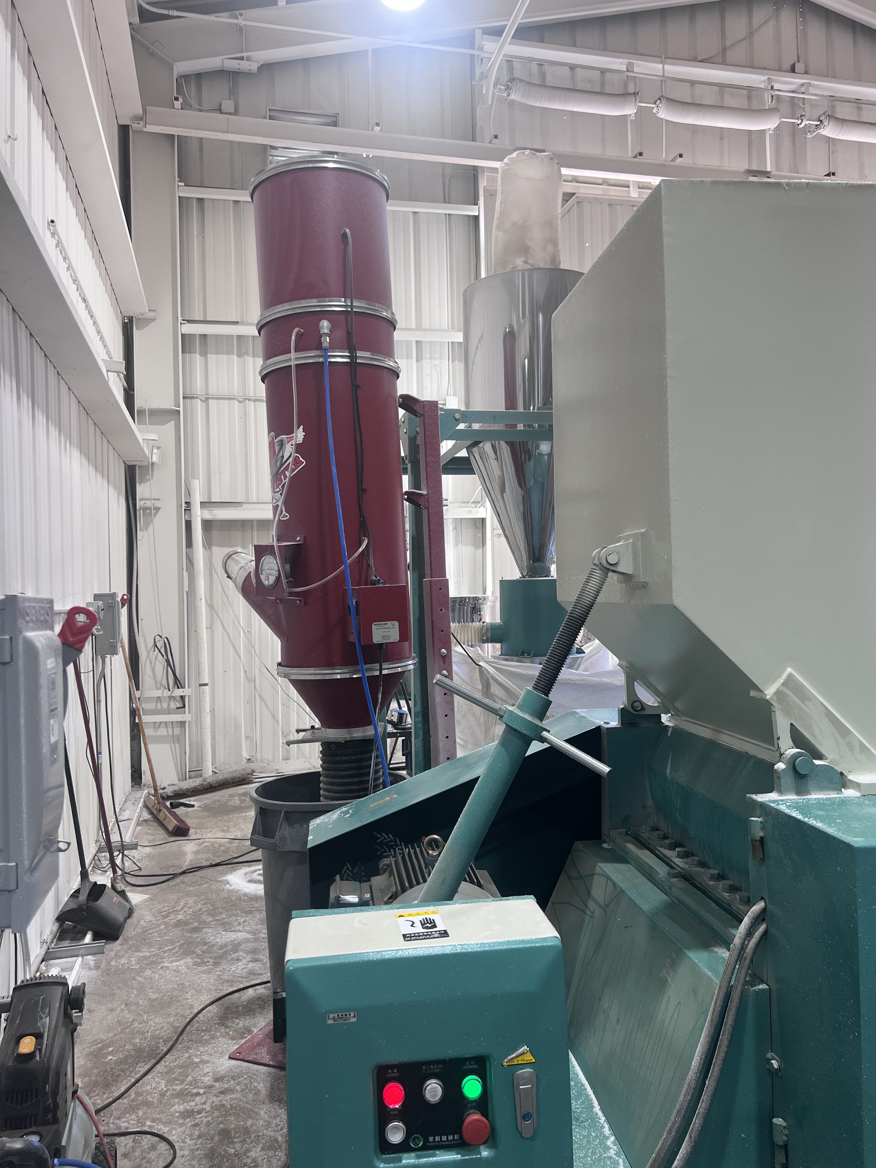 RP1 cyclone (maroon) installed downstream of stainless separator at Arizona plastics manufacturer to capture fine regrind dust